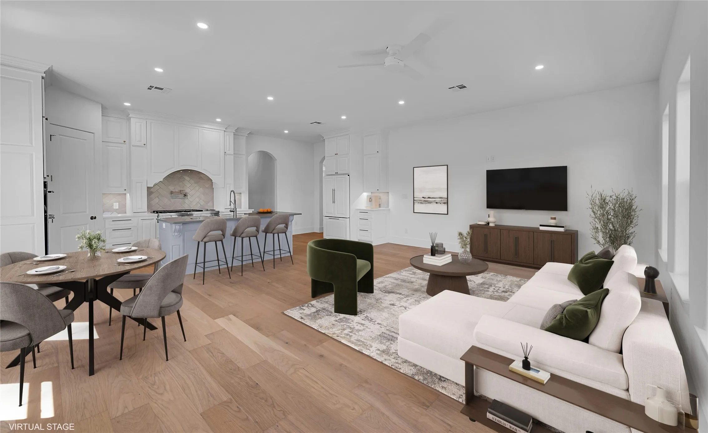 Open-concept living space featuring wood-finish flooring, recessed lighting, and a neutral color palette
