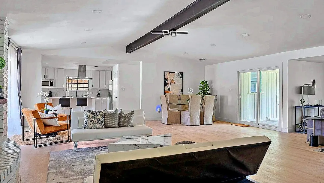 Open-concept living area with light wood-finish flooring