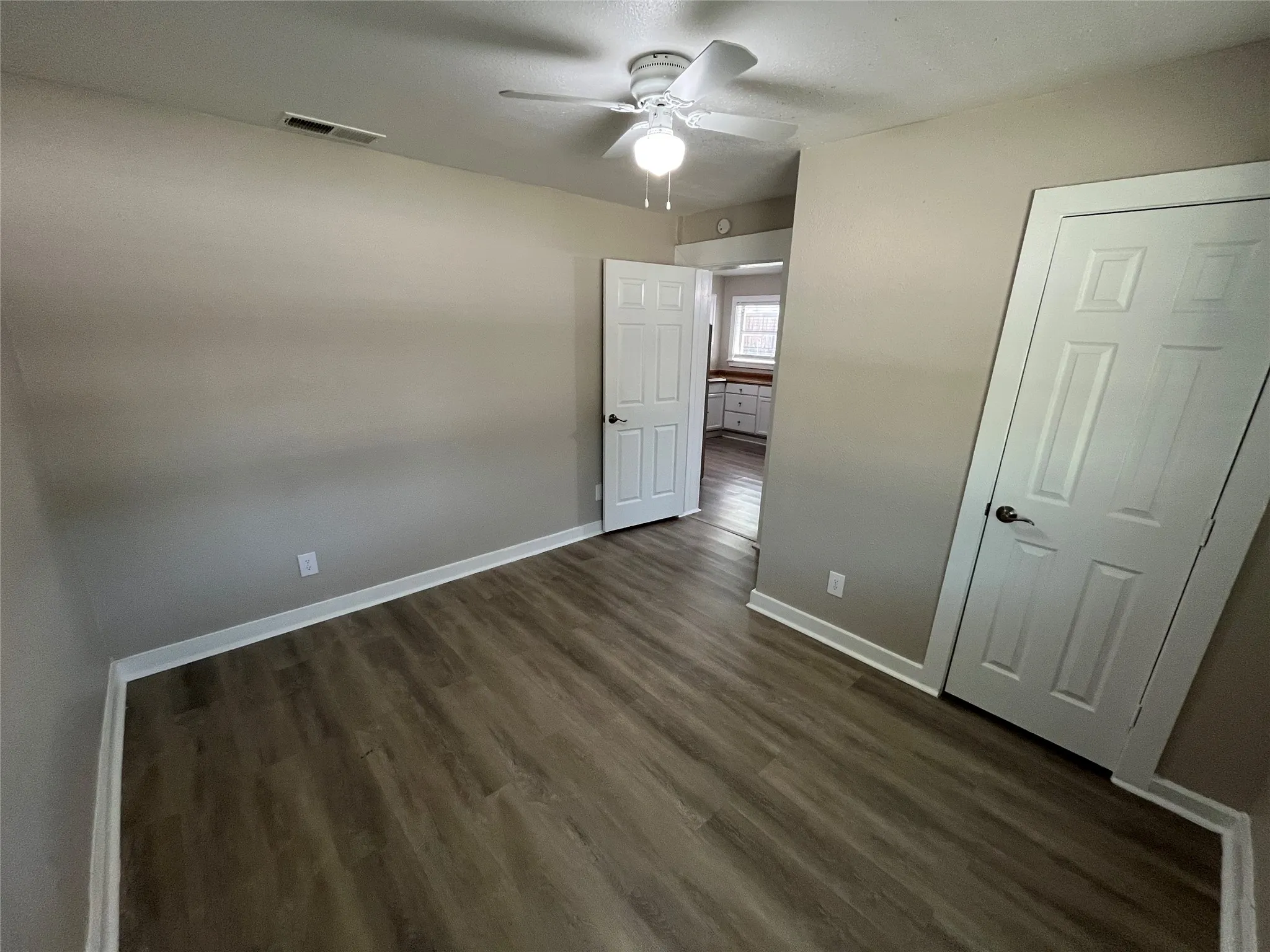 Interior room featuring wood-finish flooring and neutral wall tones