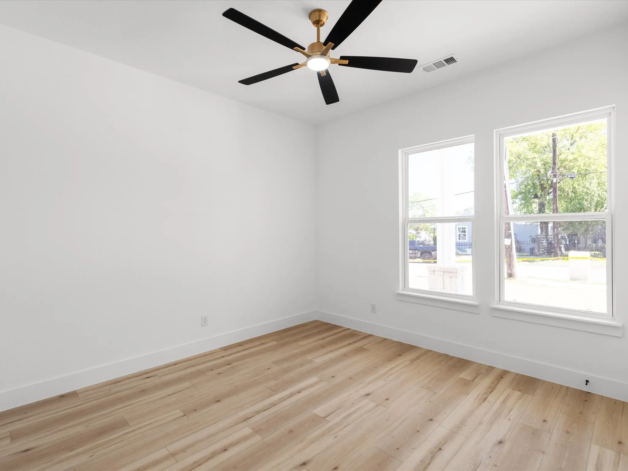 Room featuring light wood-finish flooring, white walls, and white baseboards