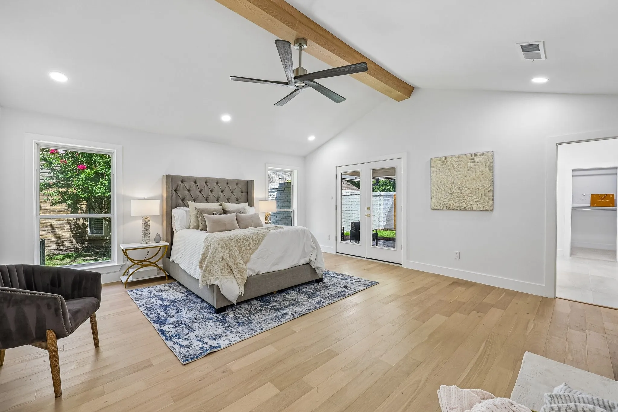 Vaulted ceiling featuring an exposed wood beam and recessed lighting