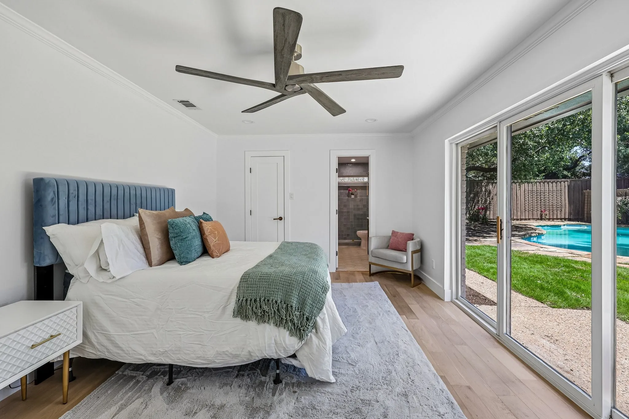 Bedroom featuring light wood-finish flooring and crown molding
