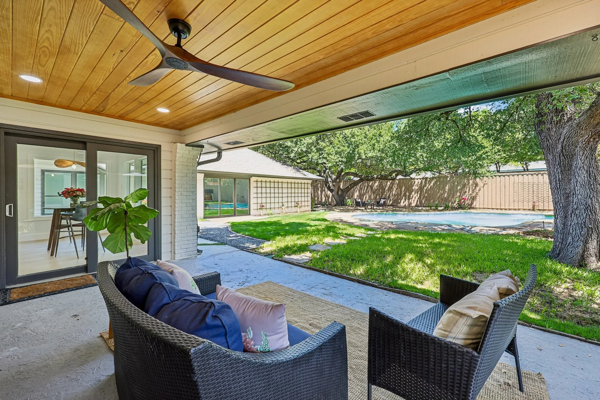Covered patio with a wood-finish ceiling, recessed lighting, and a modern ceiling fan