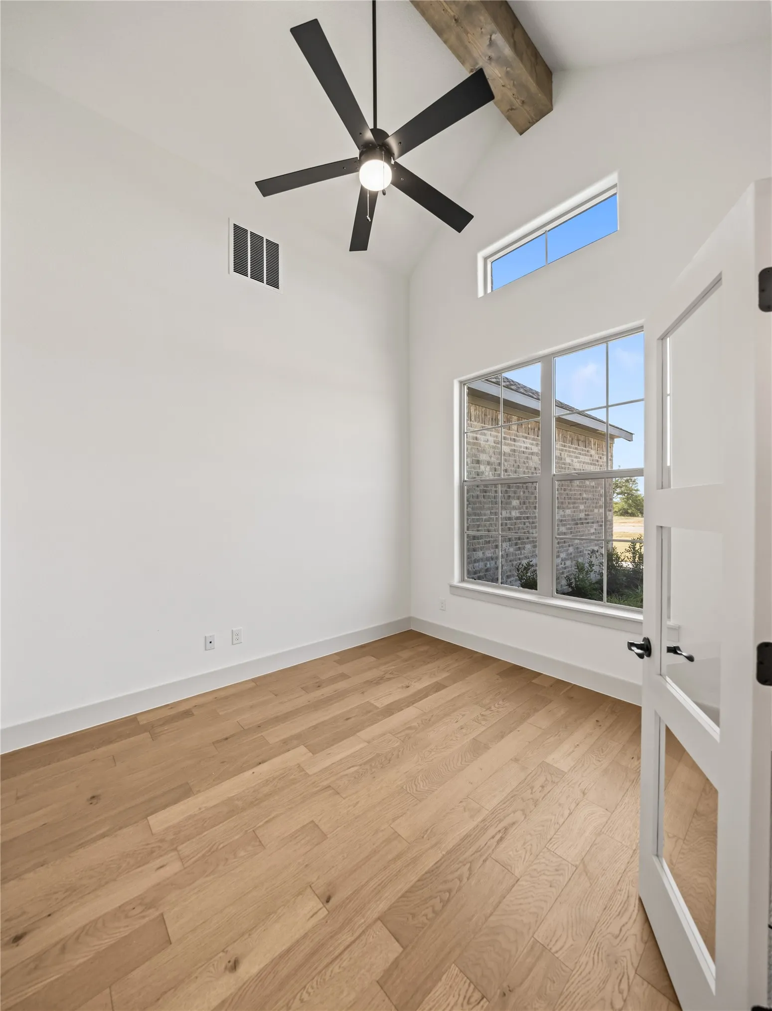 Vaulted ceiling with an exposed wood beam