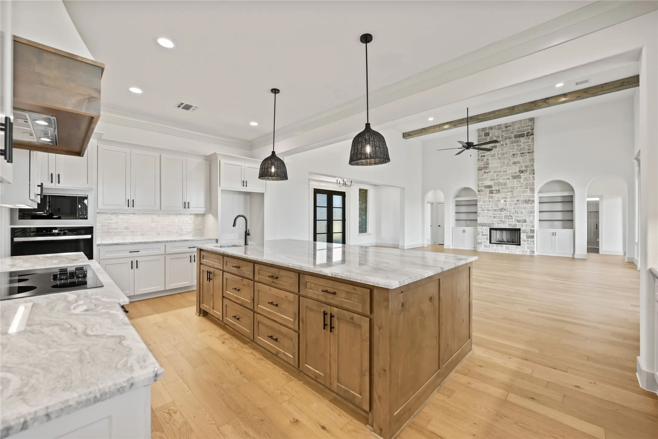 Expansive kitchen island with wood-finish cabinetry and a light-toned countertop