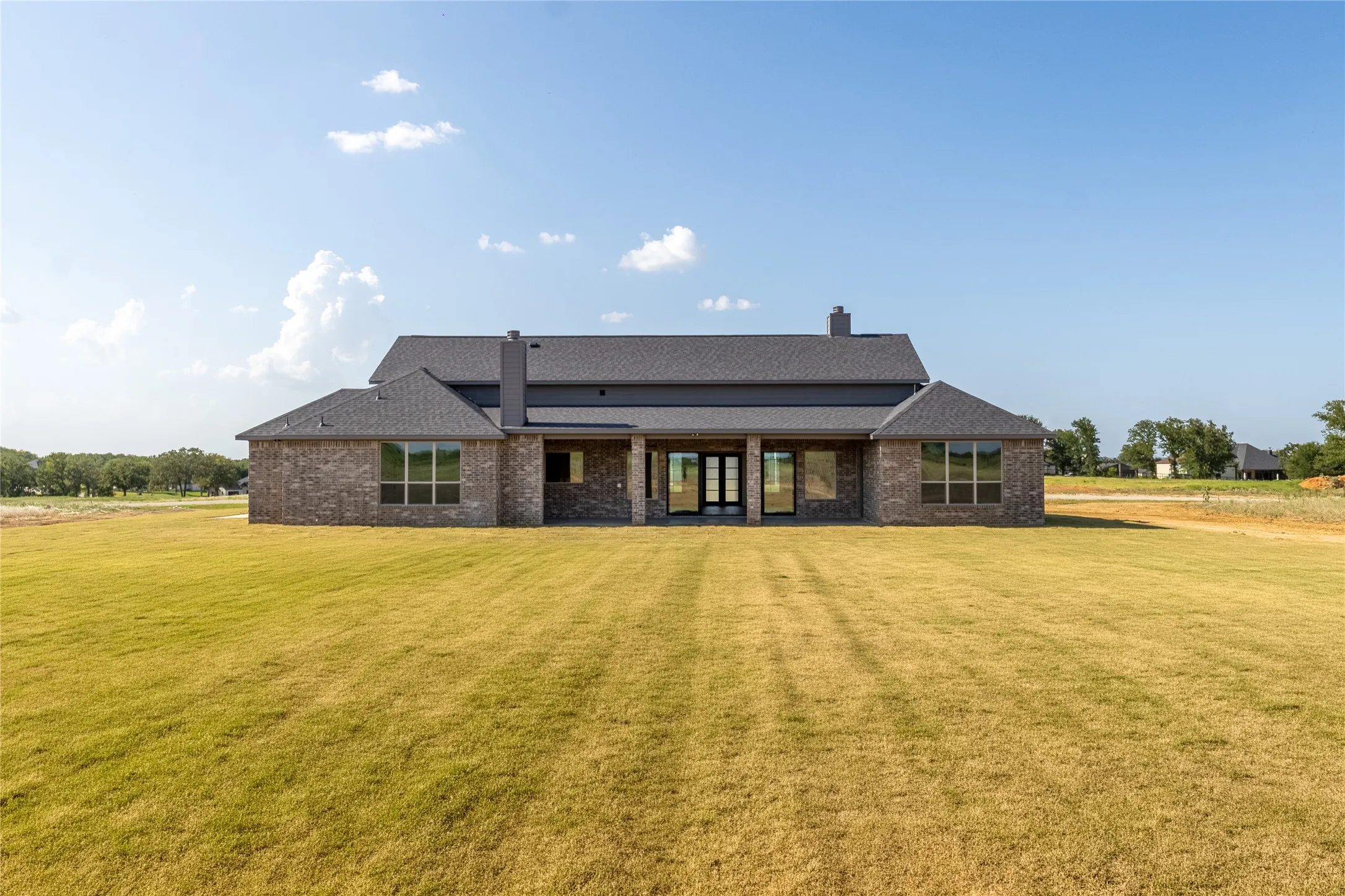 Expansive backyard featuring a manicured lawn