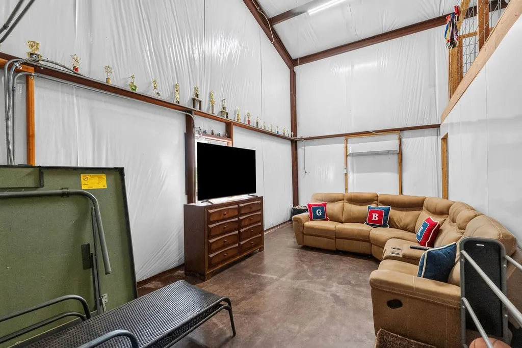 The rest of the outbuilding is set up as a hangout space, with insulation and a mini-split Ac unit, with loft space and 1/2 bath. Could easily be re-converted into a garage or workshop space.