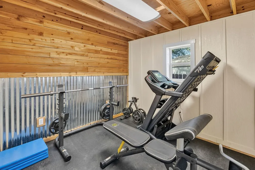 Part of the outbuilding is an 11x11 finished room, currently set up as a gym.