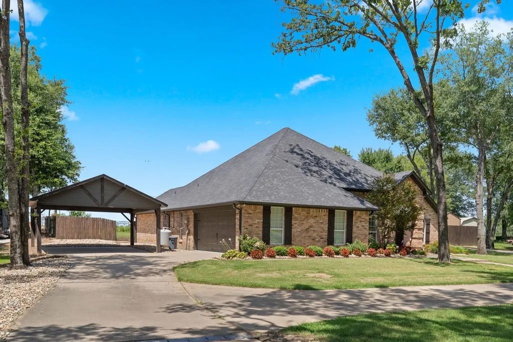 Two-car garage plus beamed wooden carport