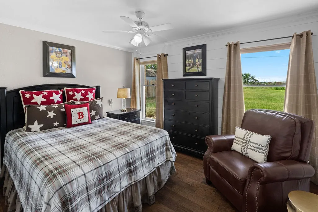Bedrooms 2 and 3 are in their own wing, and share a hall bath.  This bedroom has a pretty wooden wall.
