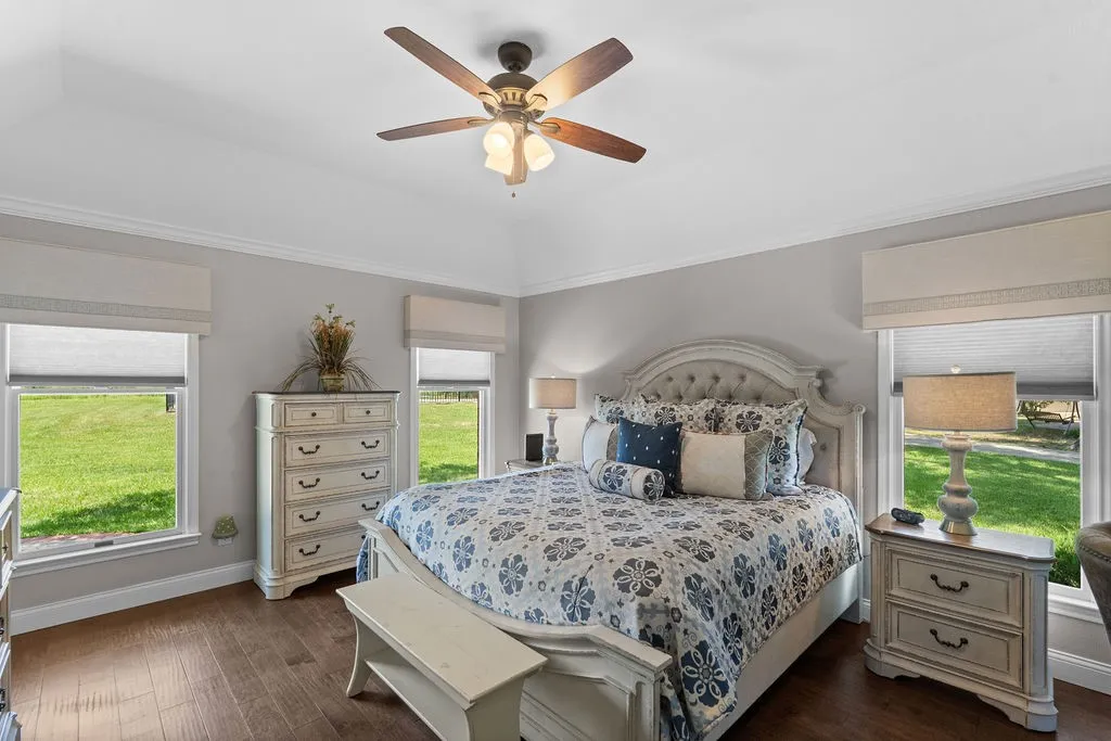 Separated in its own wing, the primary suite has three large windows, a raised ceiling, ensuite spa-like bath and THREE closets.