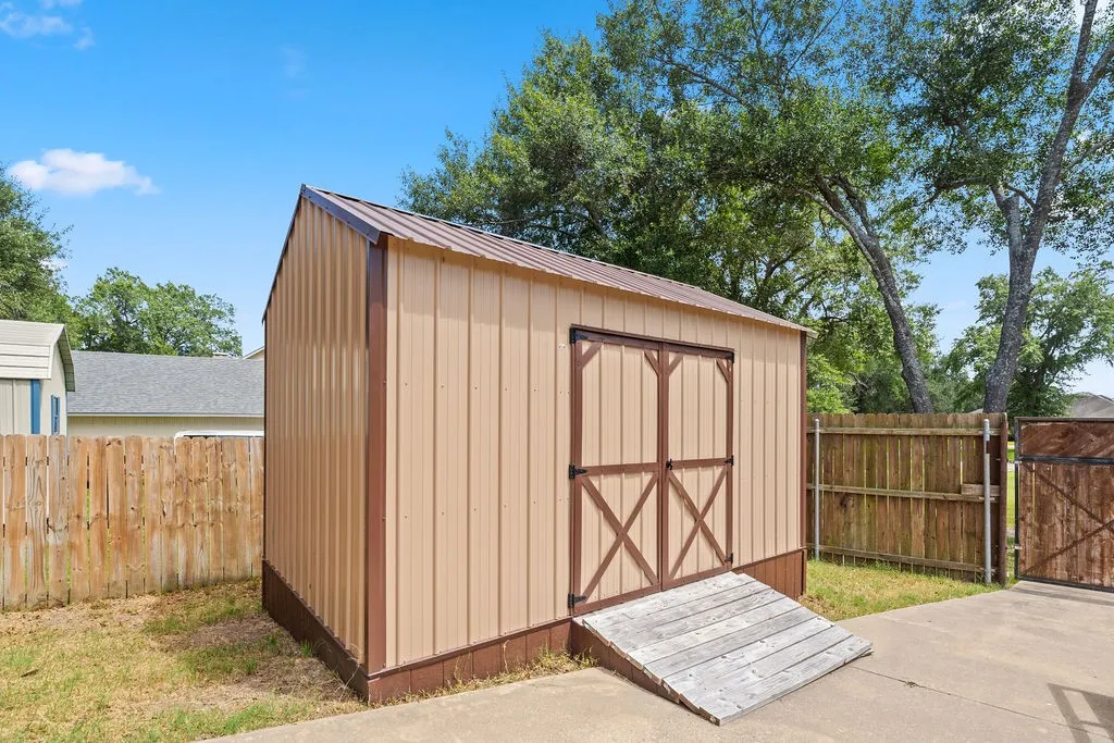 also in the back yard is a 16x10 metal shed with ramp, perfect for lawn equipment