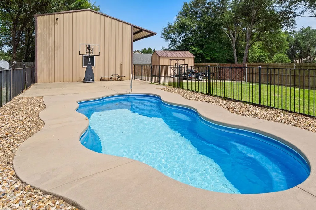 Pool has area for basketball goal next to the workshop/garage.
