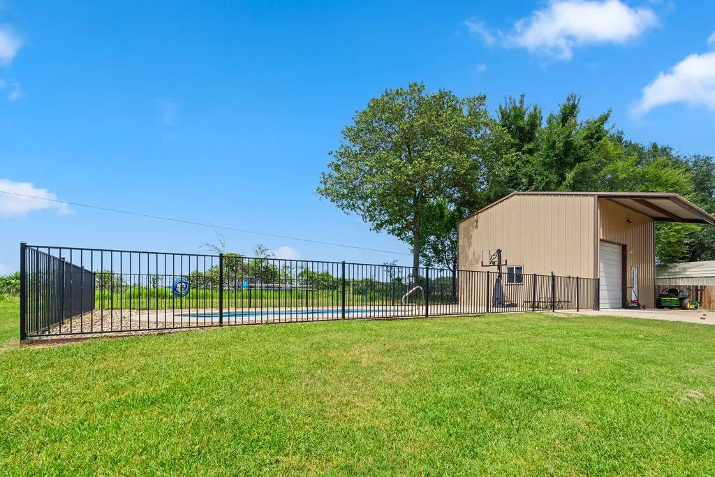 At the back of your yard is a fenced-in in-ground pool!