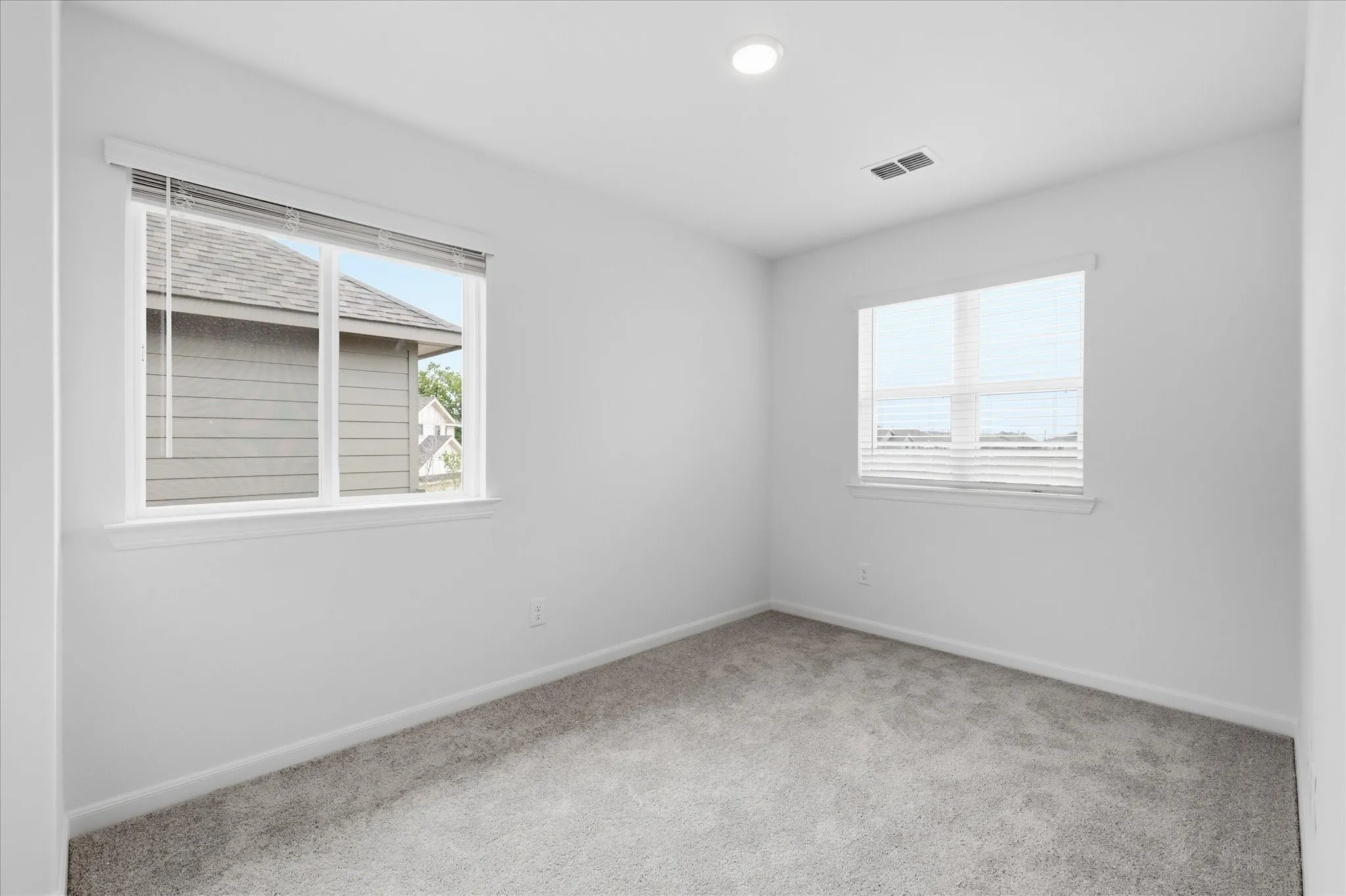 Neutral wall tones with soft carpet flooring