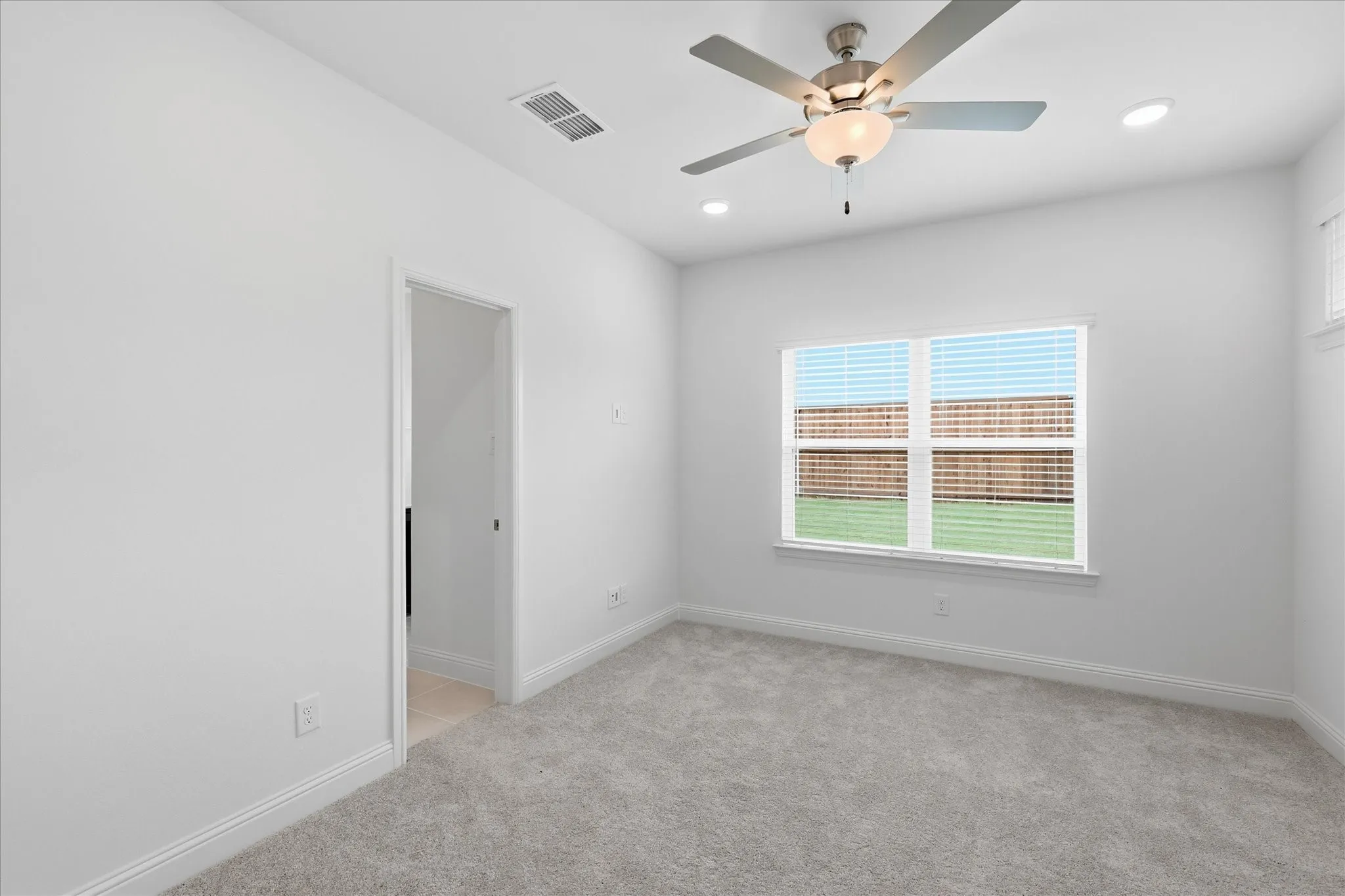 Neutral tone carpeting and white baseboards