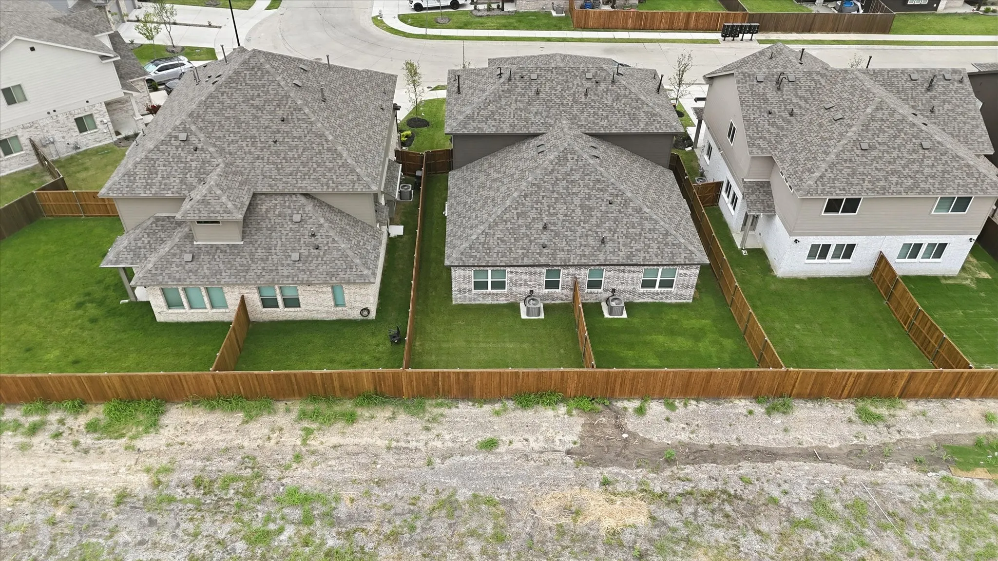 Newly constructed homes featuring a combination of brick and siding exteriors