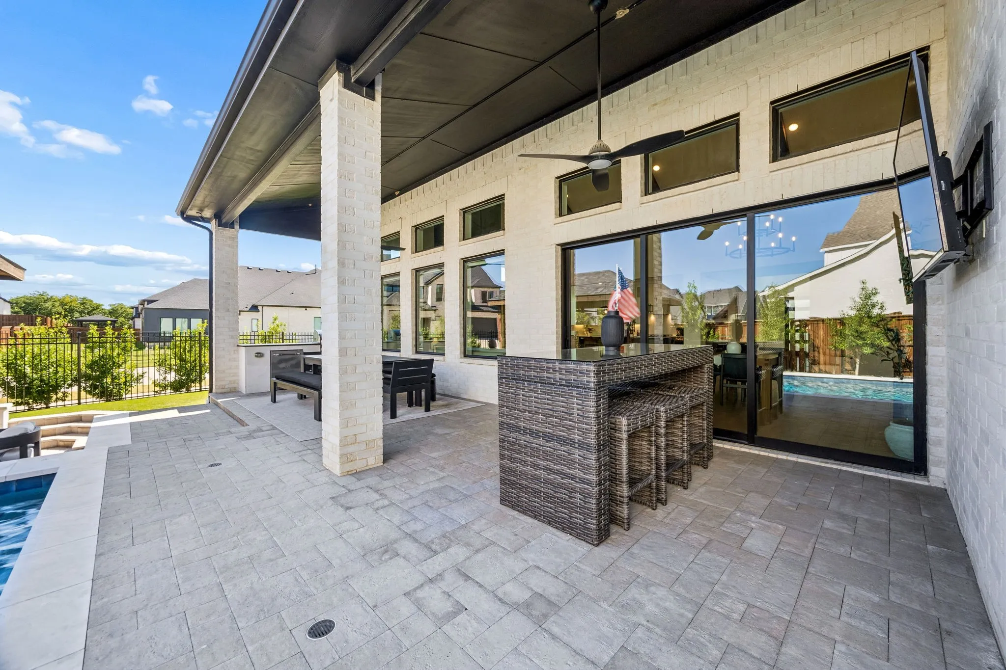 Covered patio featuring paver flooring, a ceiling fan, and recessed lighting.