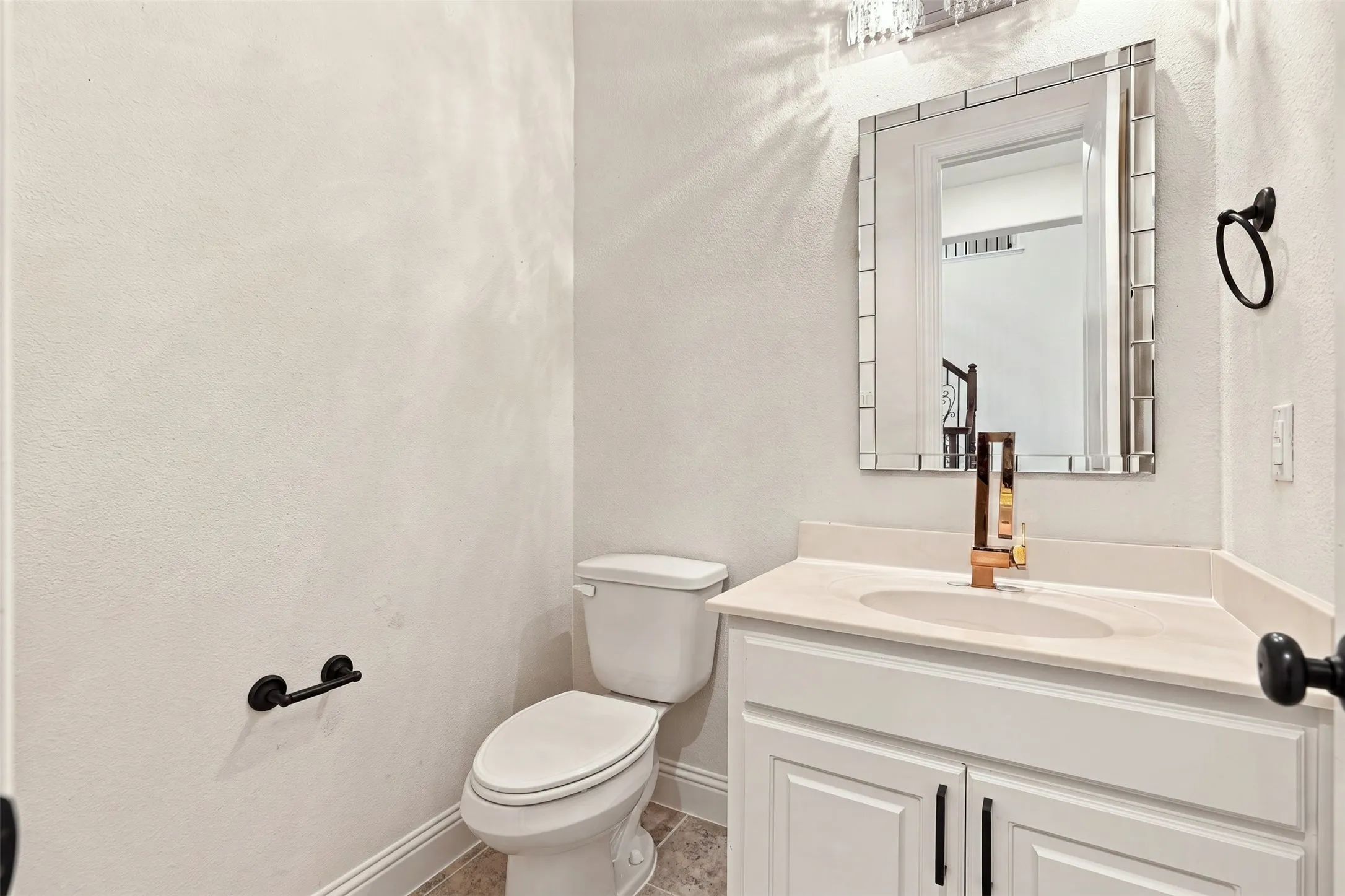 White vanity with a light-toned countertop and an integrated sink
