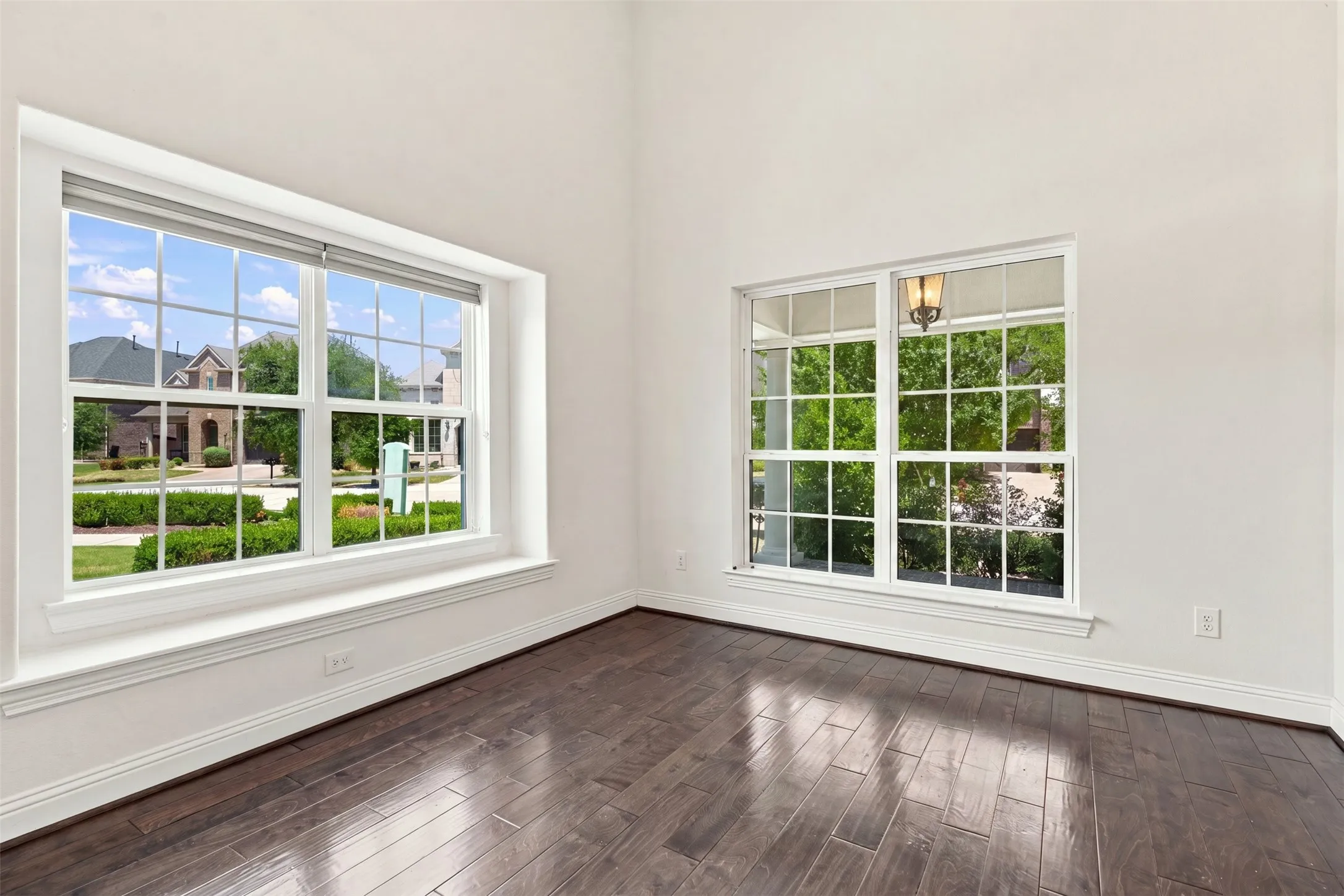 Bright room featuring two large windows with white muntins