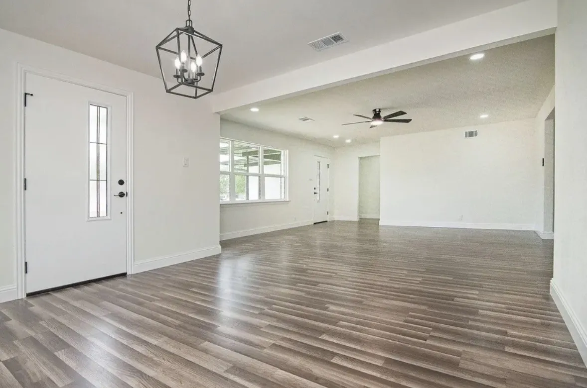 Open concept living area featuring wood-finish flooring, recessed lighting, and a contemporary ceiling fan