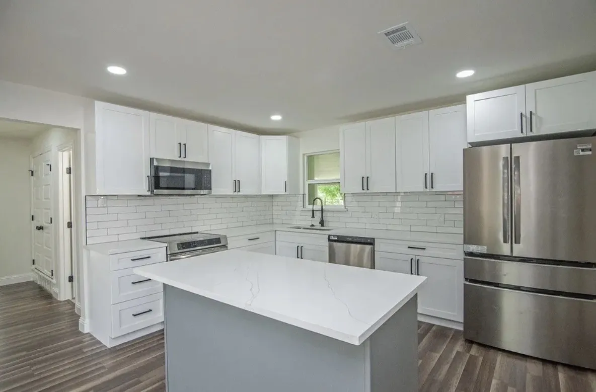 Modern kitchen with a central island featuring a white countertop