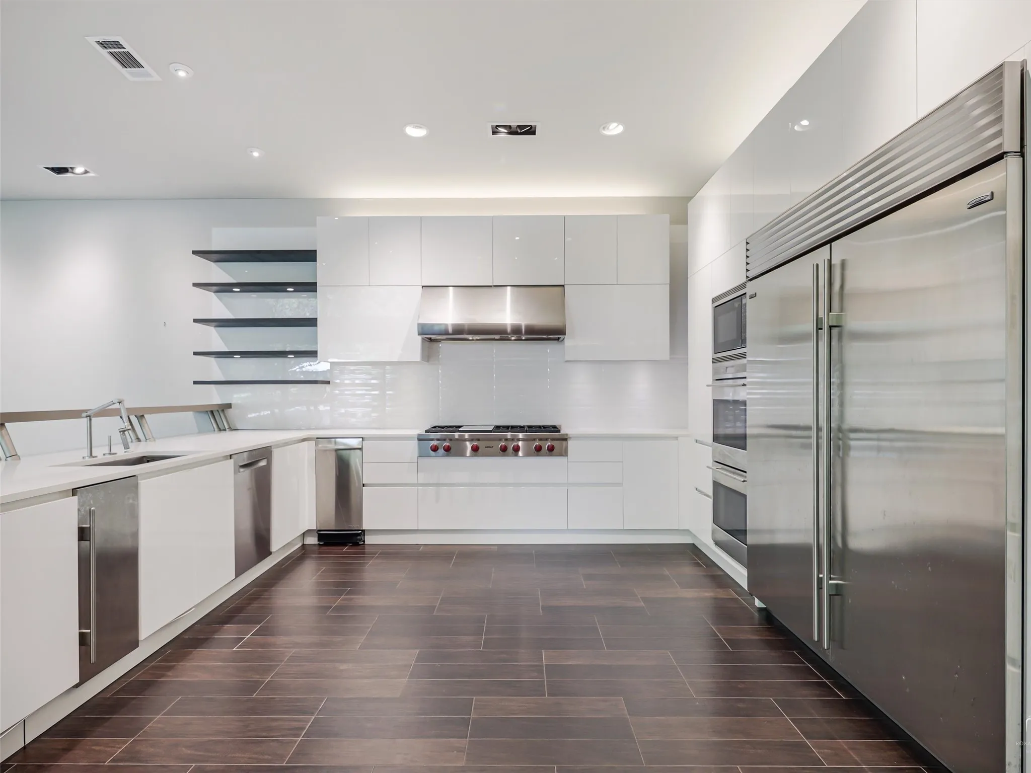 Commercial kitchen with tons of counterspace, freezers, refrigerators, warming drawers