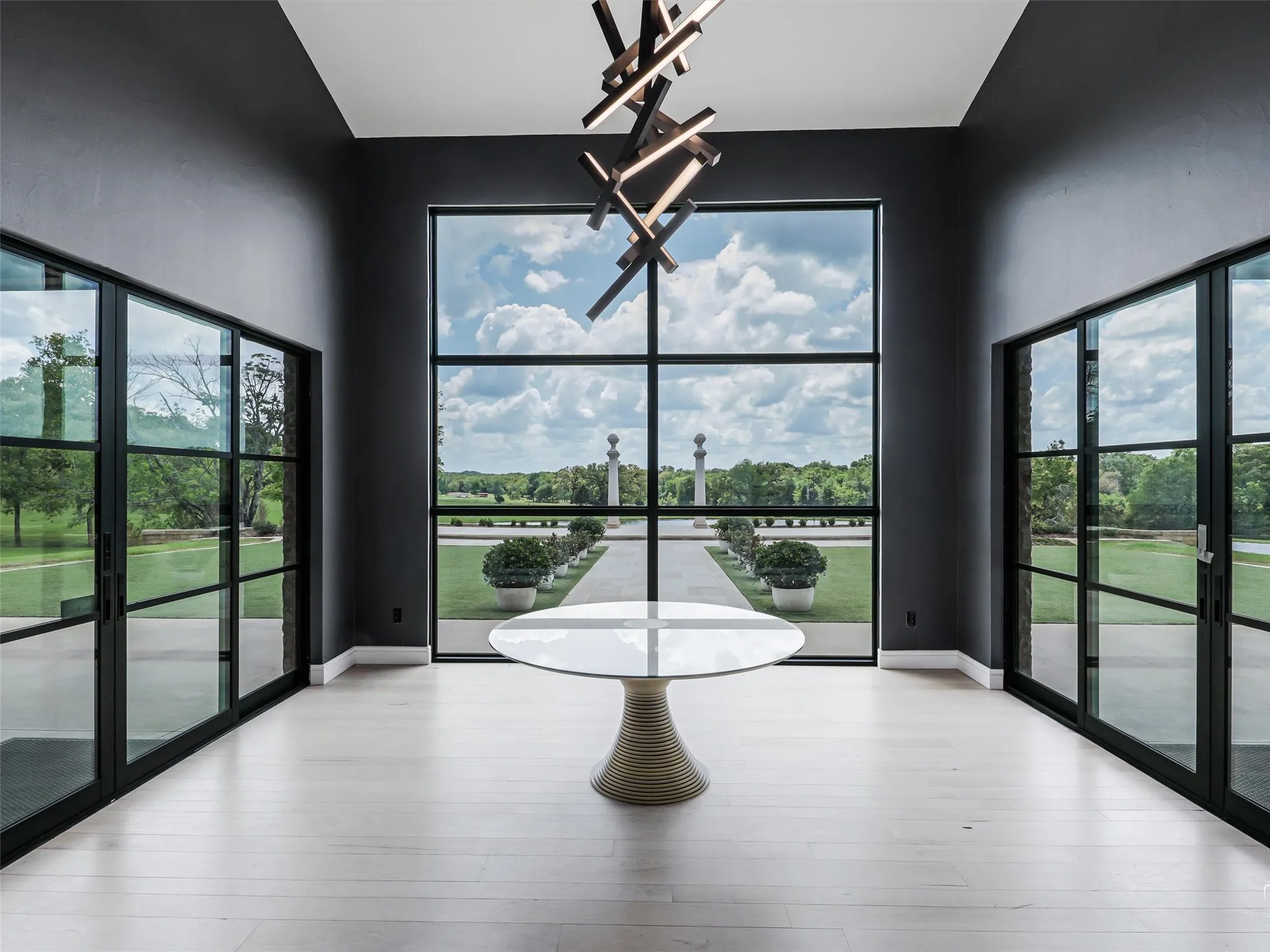 Entry with soaring ceilings and floor to ceiling windows