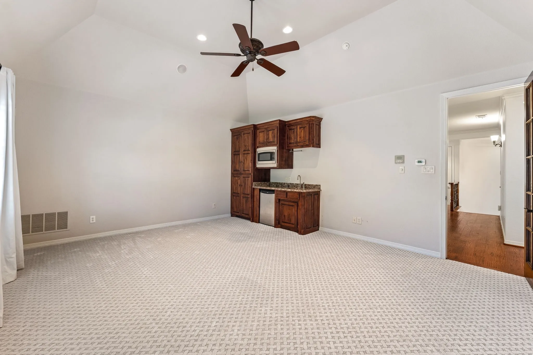 Game Room Built in cabinets, fridge, microwave, sink.