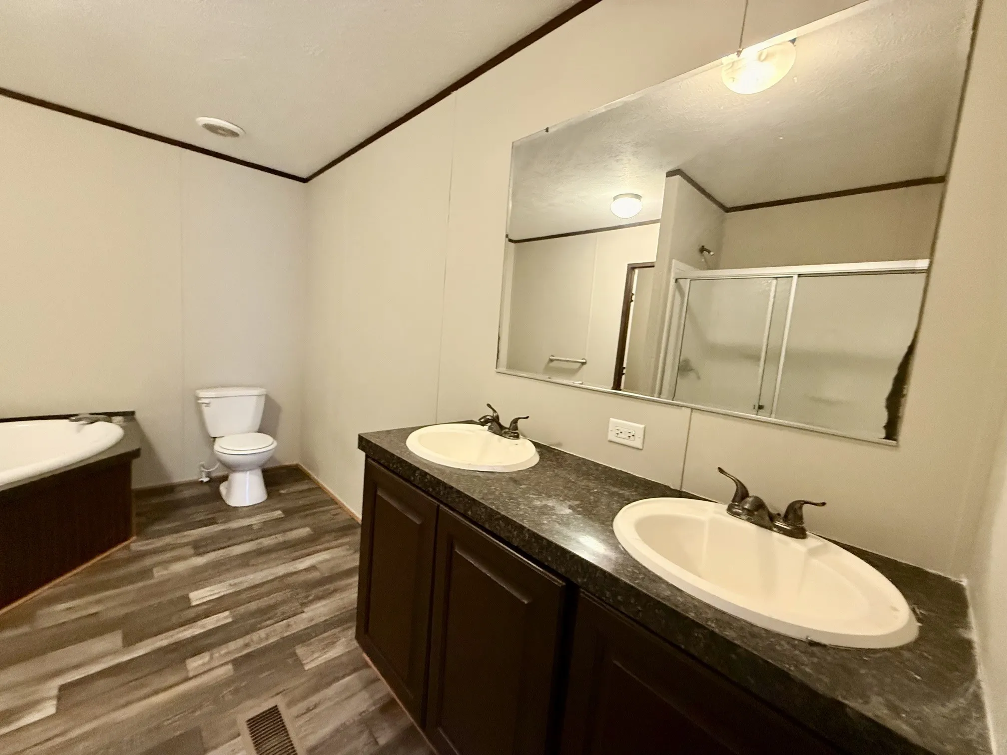 Double vanity with dark countertops and integrated sinks