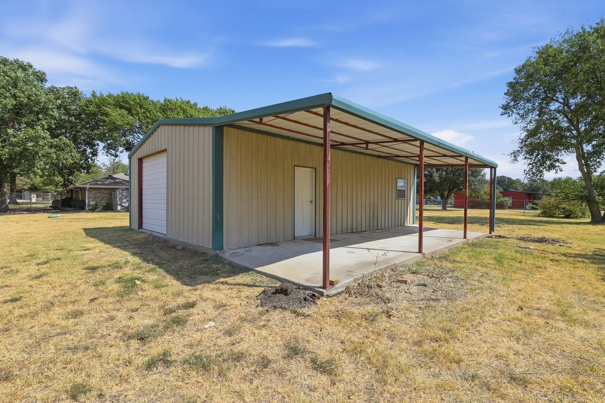 30x40 Workshop with electricity and additional covered storage.
