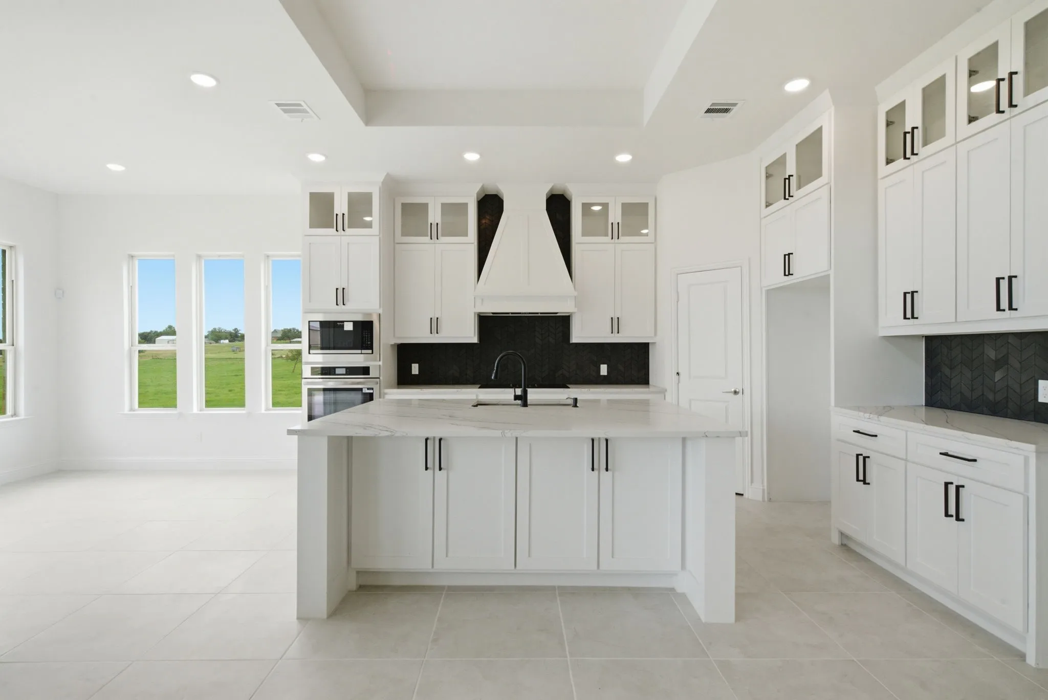 Huge island, custom vent with really pretty backsplash!