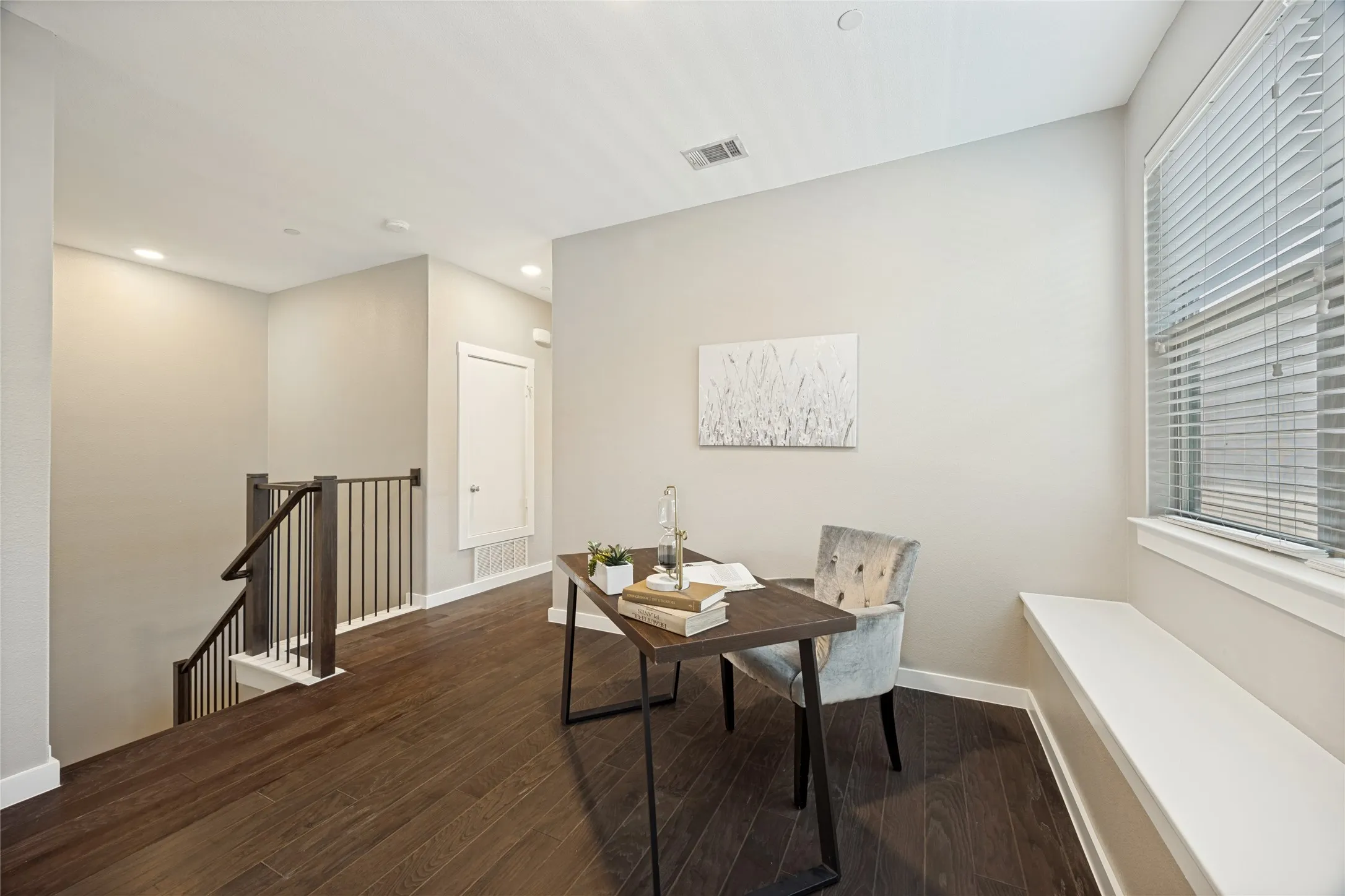 The space at the top of the landing can be used in various ways. Here it is styled as a home office, you could also use it for a teen hangout, a second living space, or a playroom for kids.