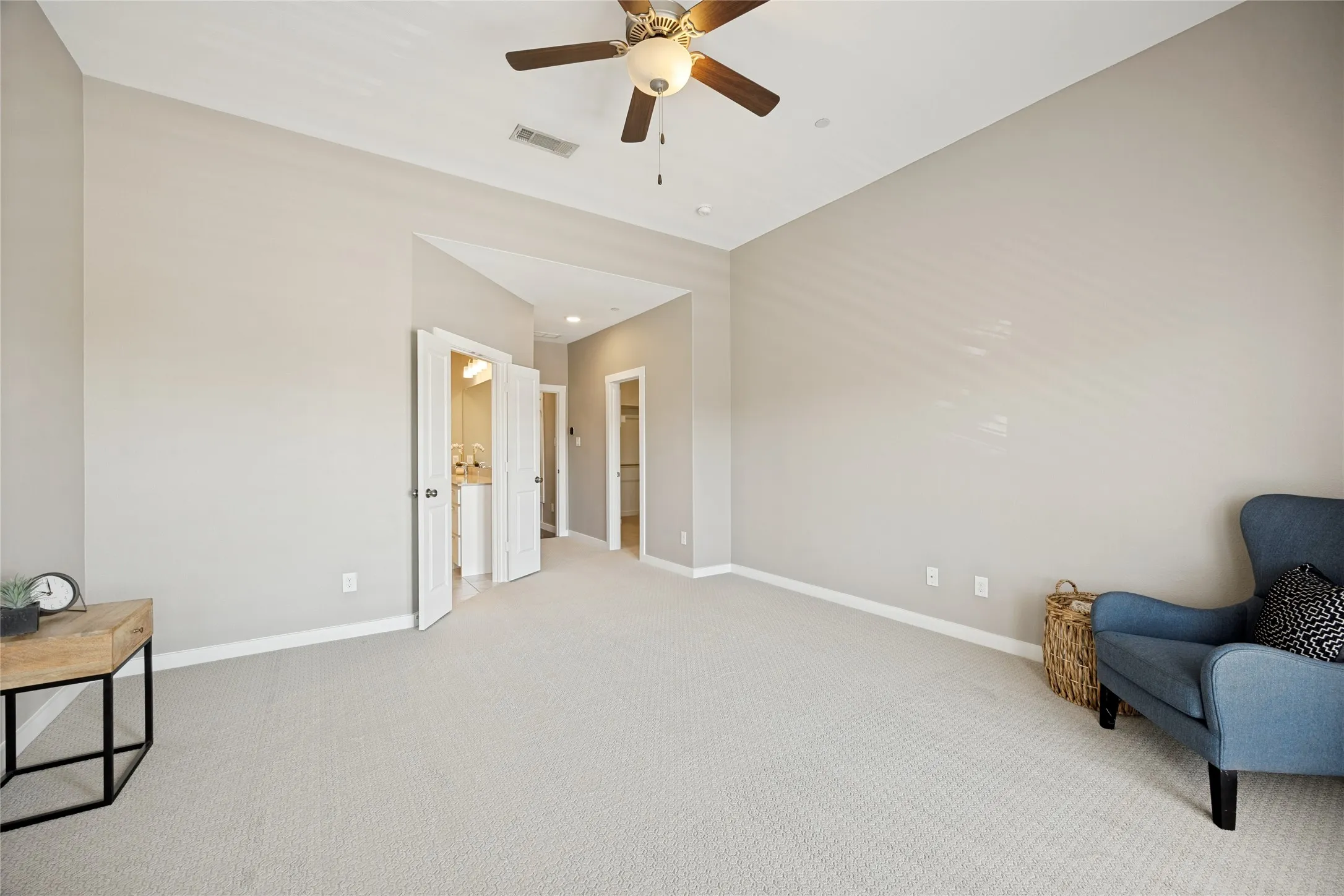 The primary bedroom, with balcony, ensuite bathroom, and separate walk-in closet.