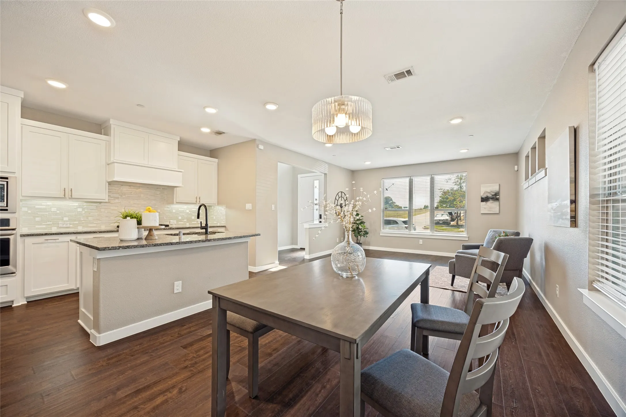 Designated dining space with chandelier and easy access to the kitchen for service.