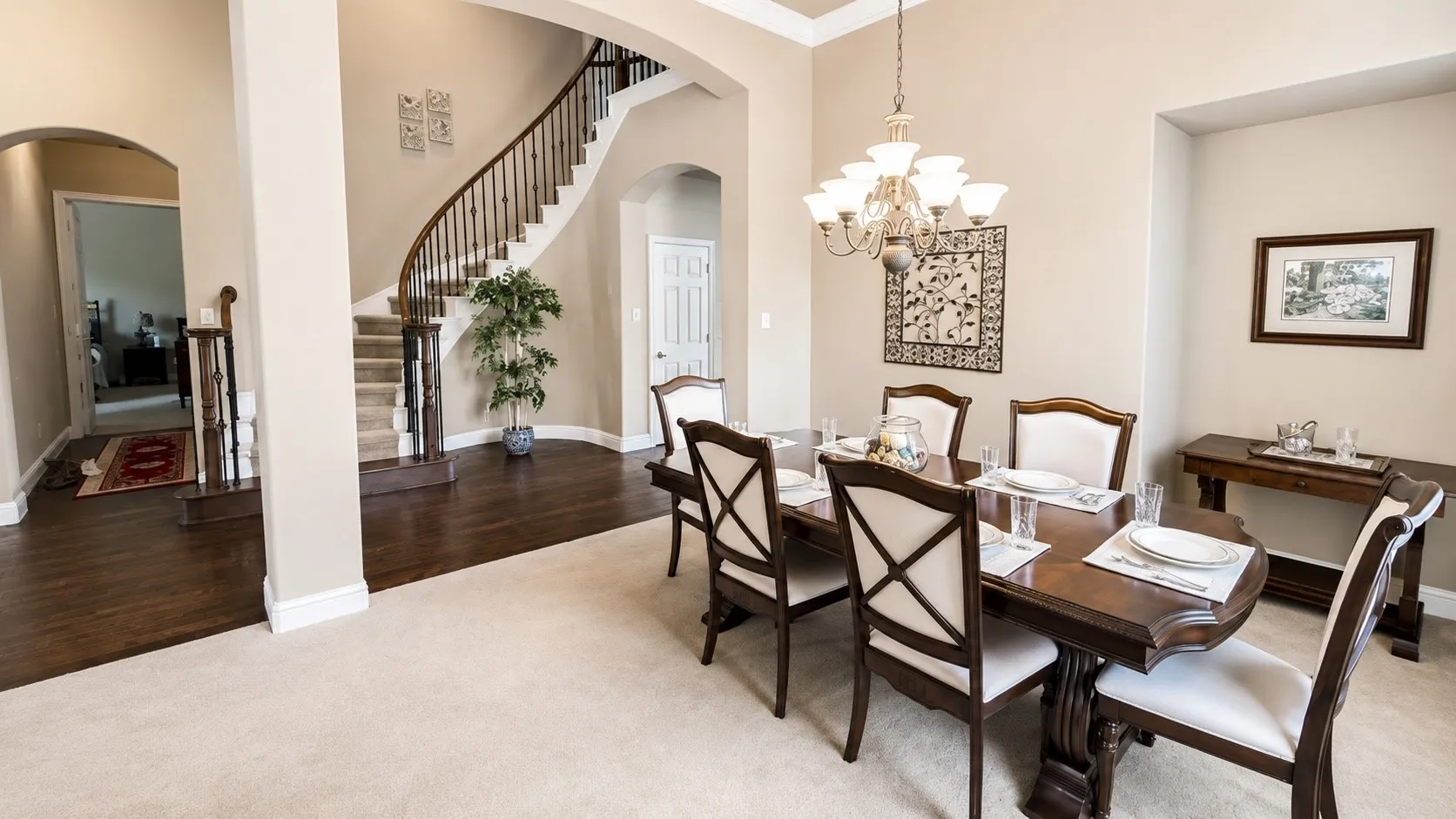 Formal dining area featuring a chandelier, tray ceiling, and arched entryway