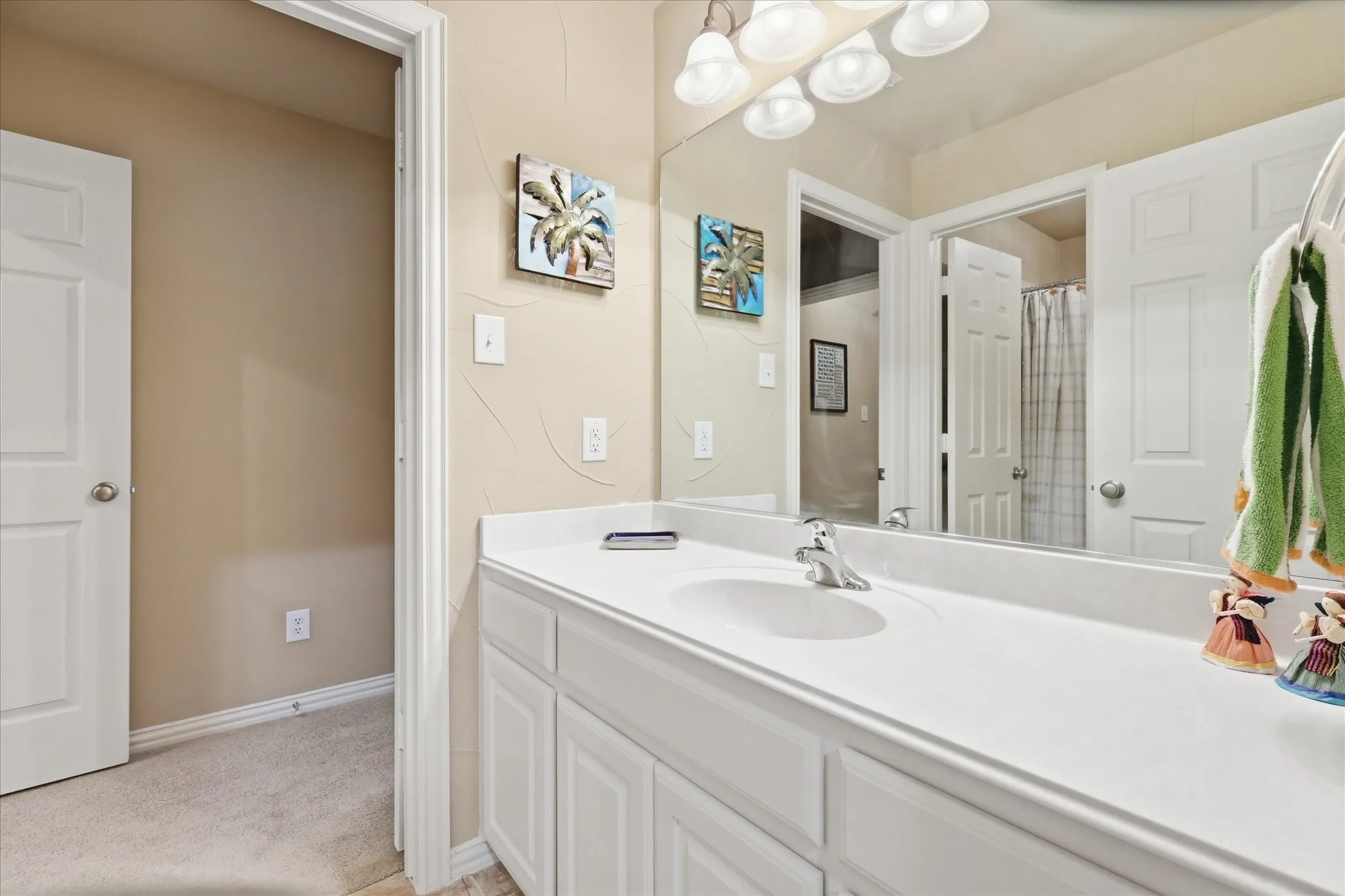 Bathroom vanity with an integrated sink, white cabinetry, and a chrome faucet