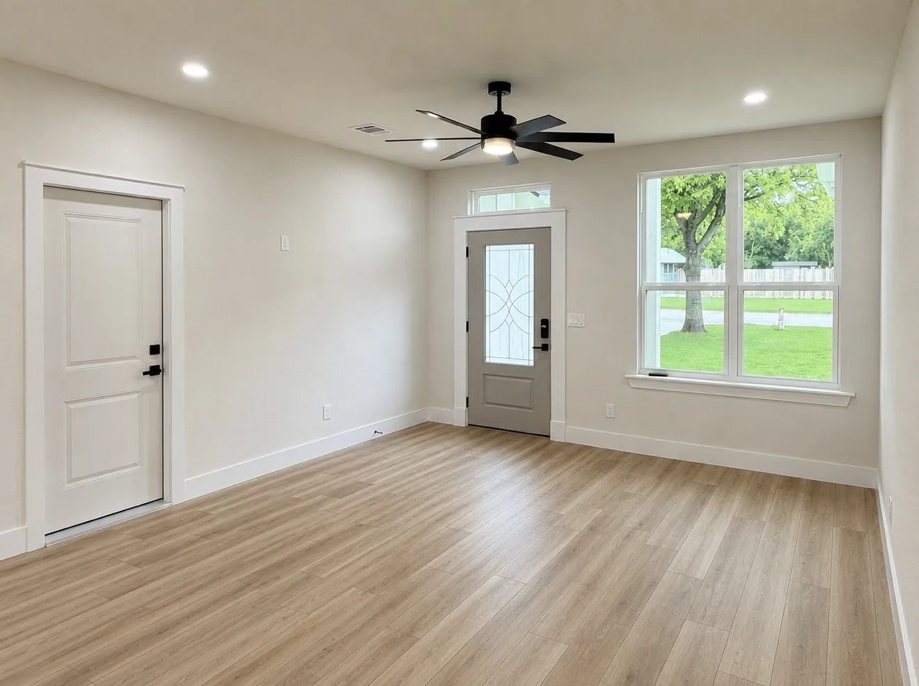 Light wood-finish flooring complements the neutral wall tones