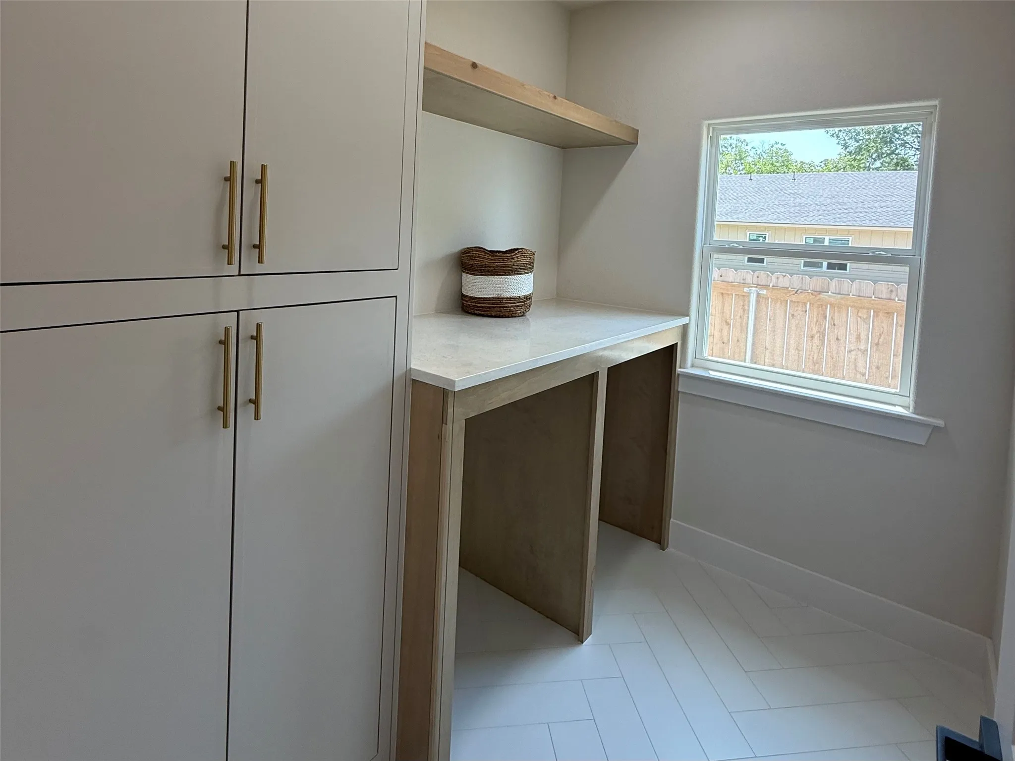 Spacious laundry room featuring extra storage.