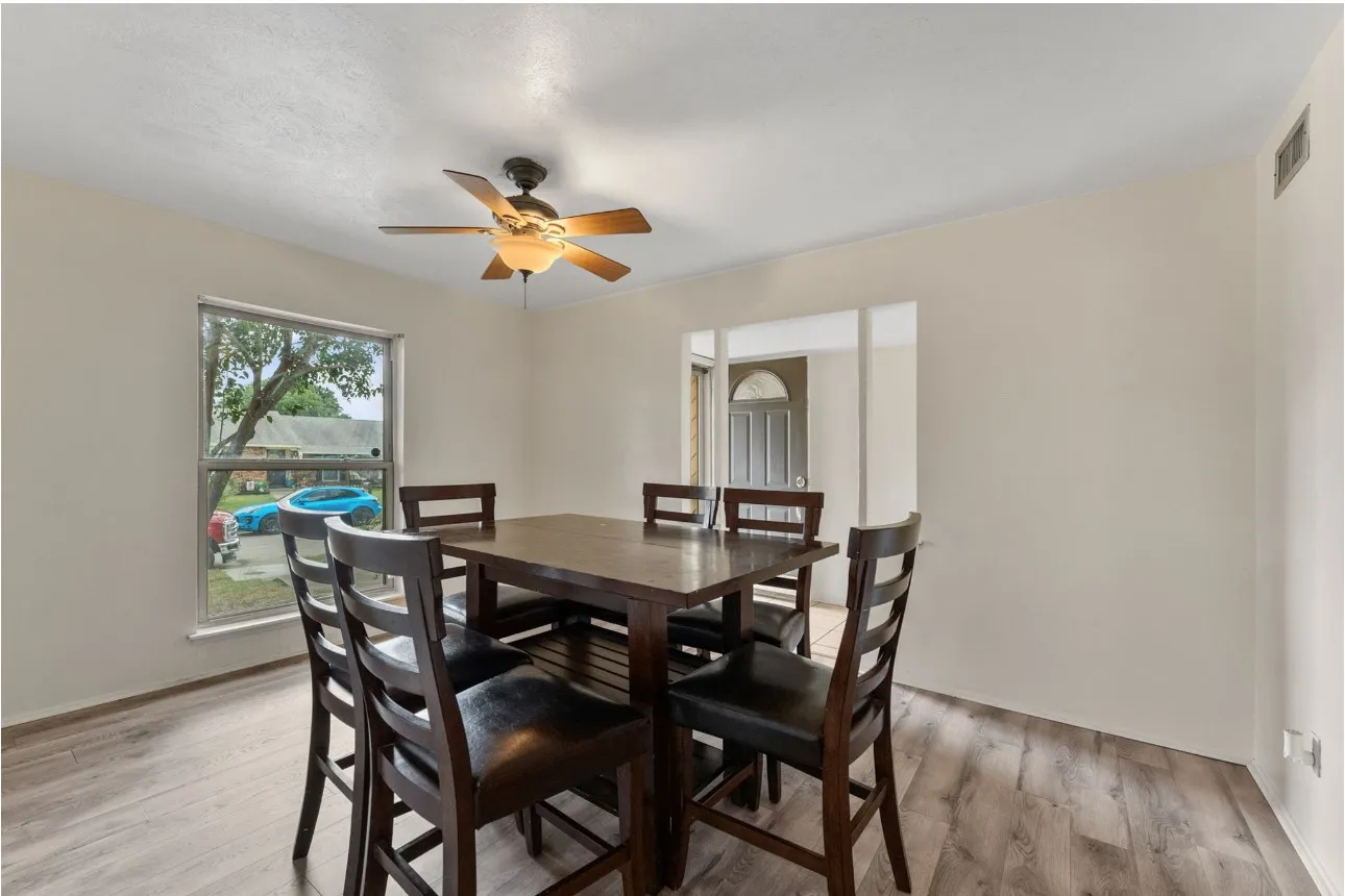 Wood-finish flooring, recessed lighting, and a ceiling fan with integrated lighting