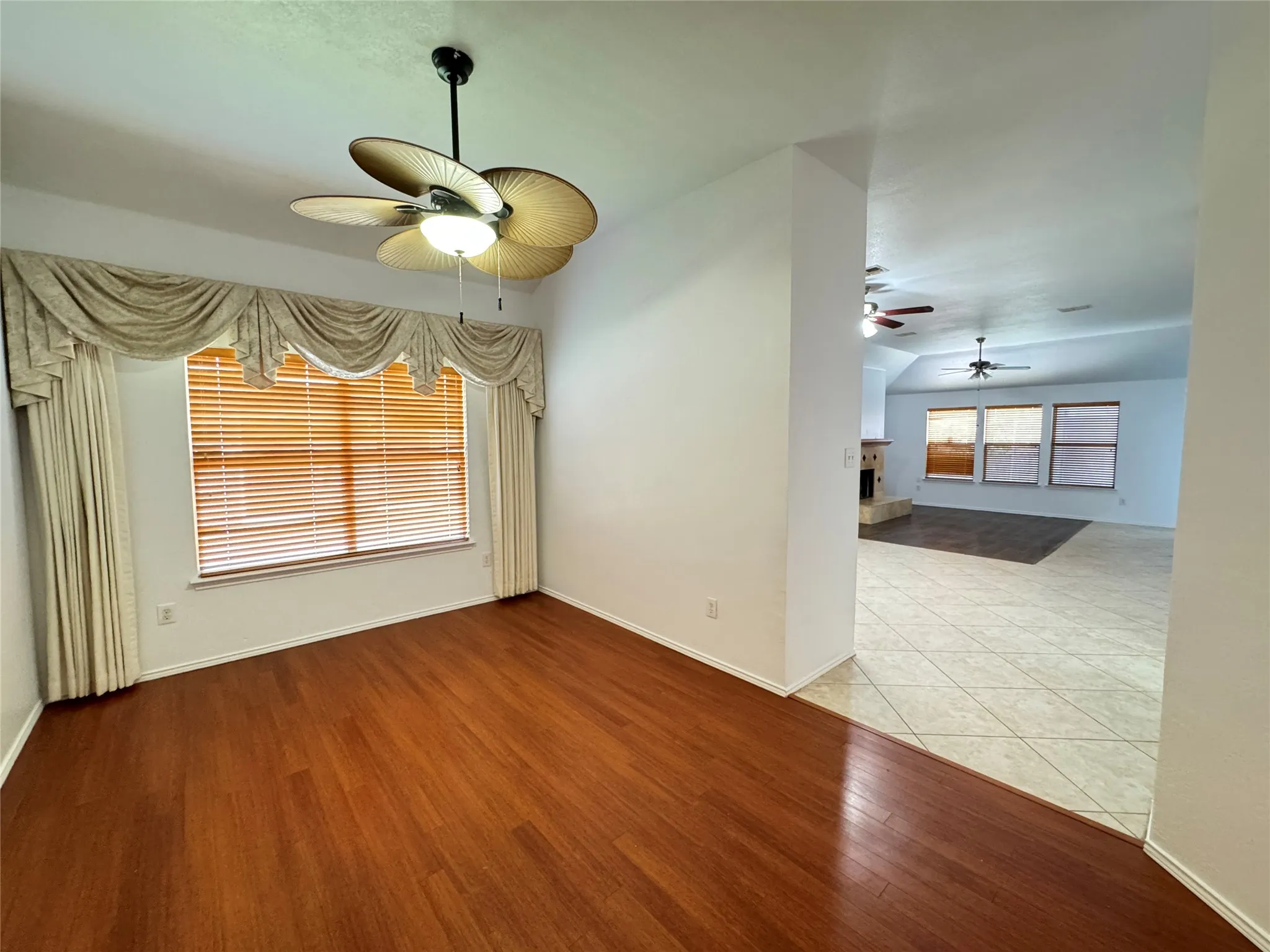 Empty room with wood-type flooring and ceiling fan