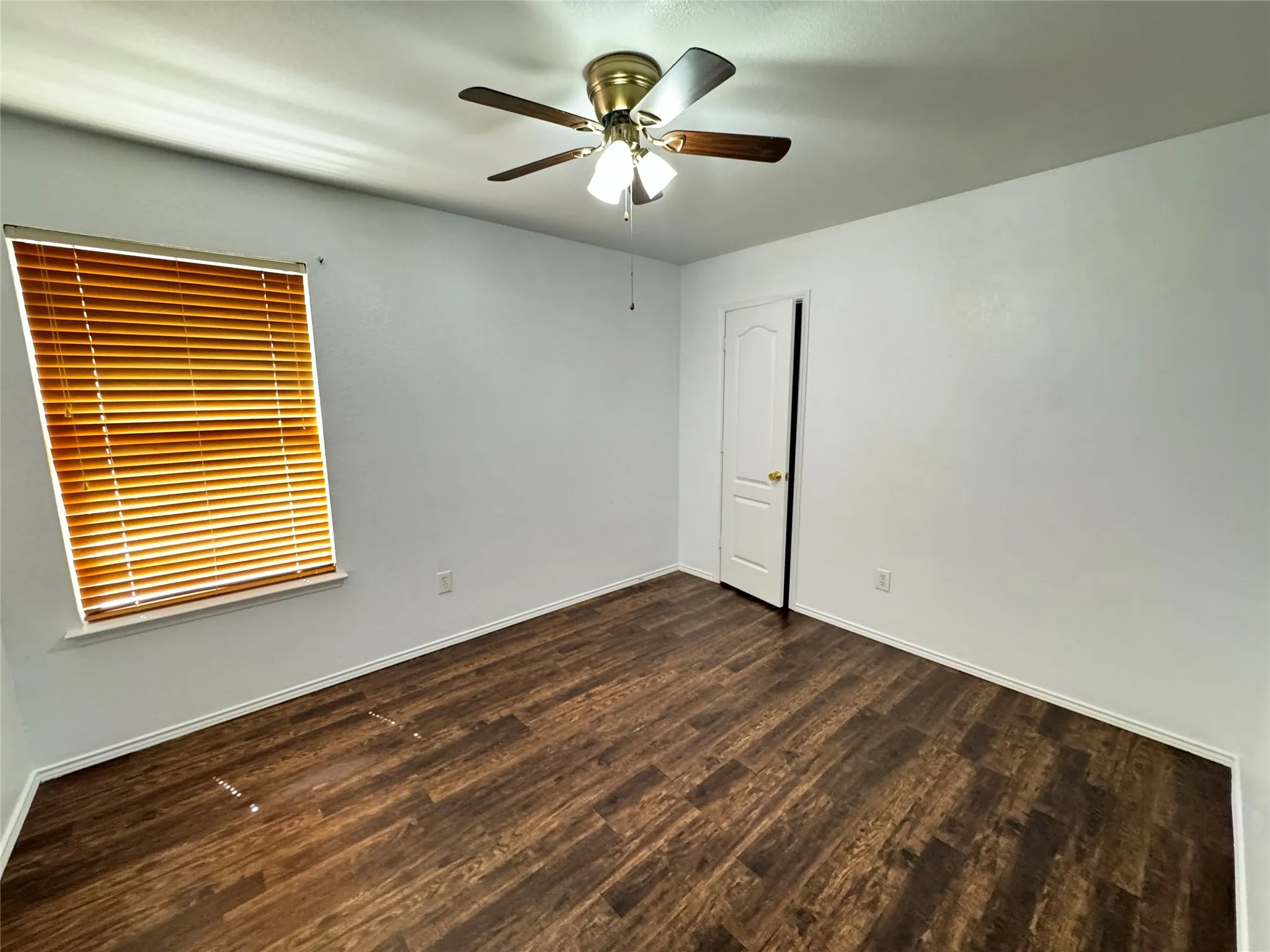 Spare room featuring hardwood / wood-style floors and ceiling fan