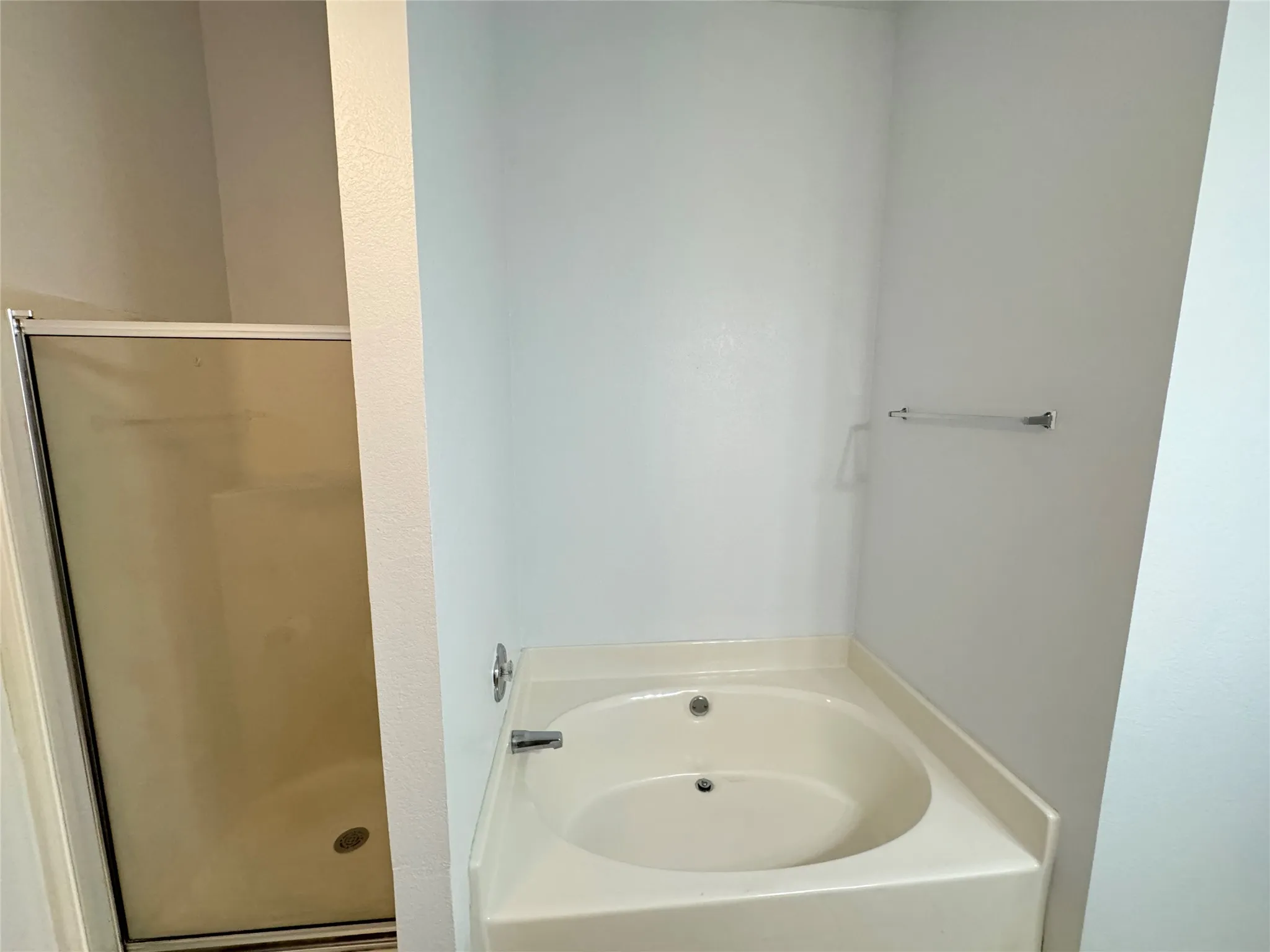 Bathroom featuring shower with separate bathtub