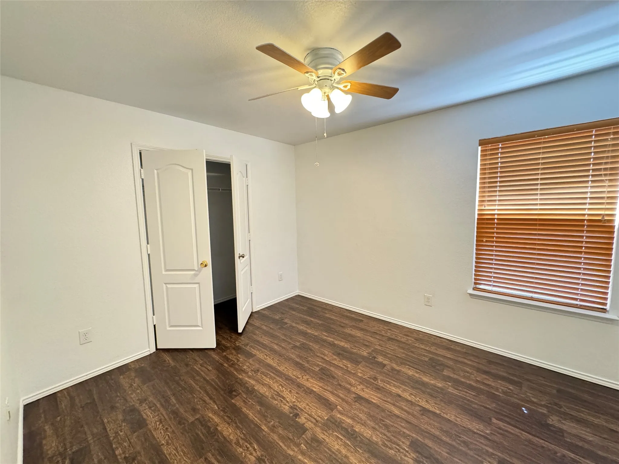 Spare room featuring ceiling fan and hardwood / wood-style flooring