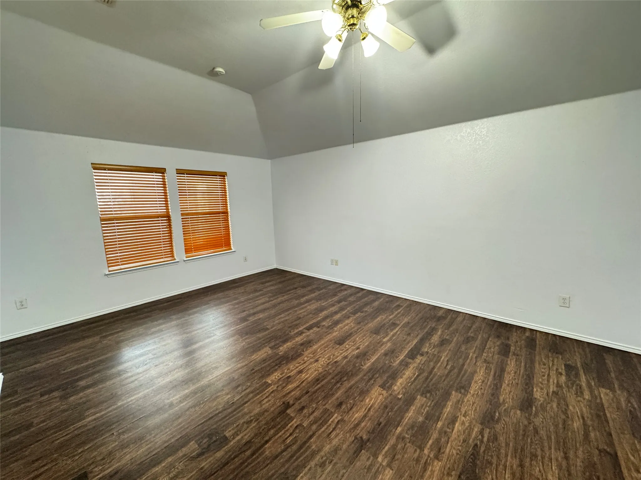 Additional living space with ceiling fan, vaulted ceiling, and hardwood / wood-style floors