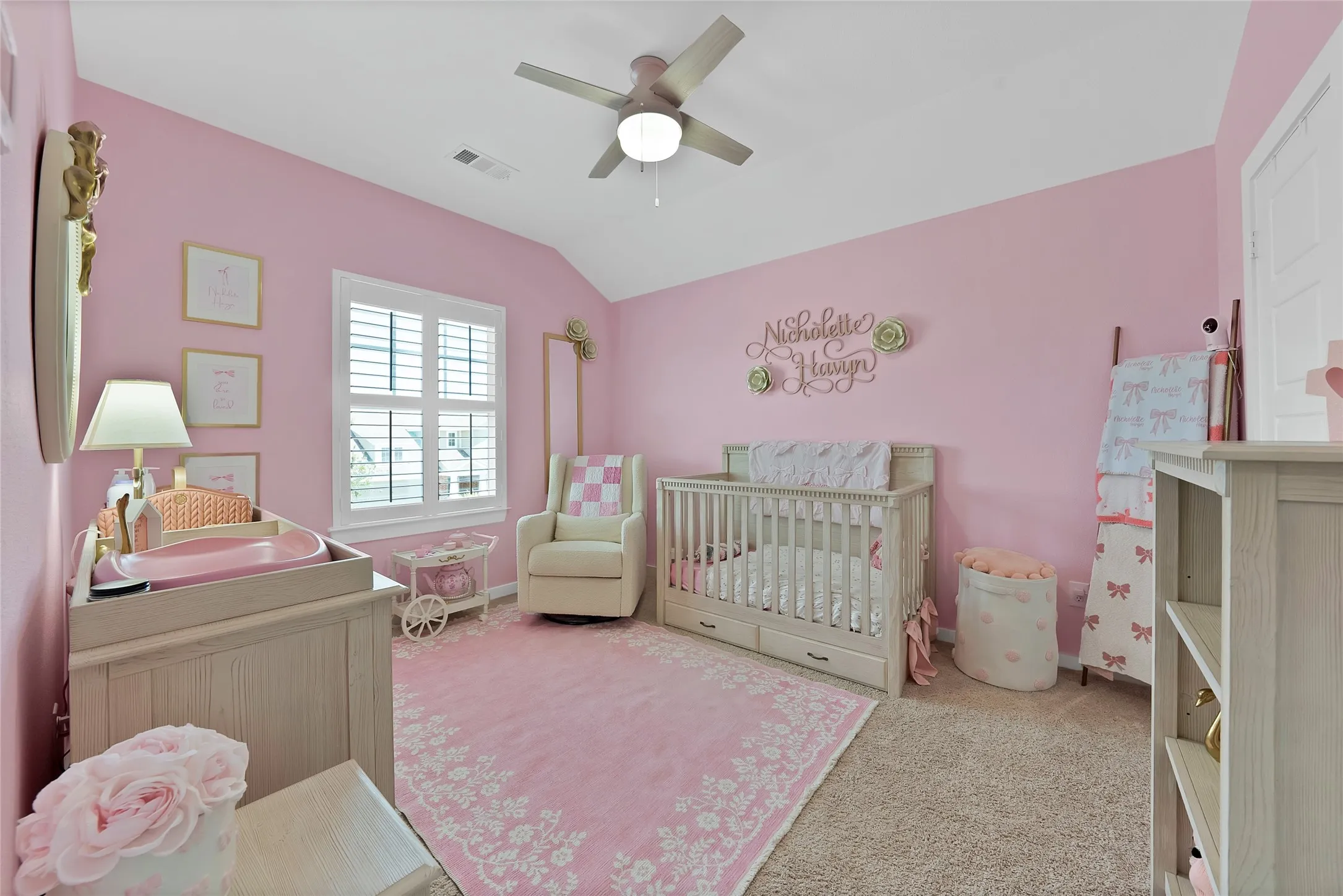 Carpeted room featuring a window with white louvered shutters, a ceiling fan, and painted walls