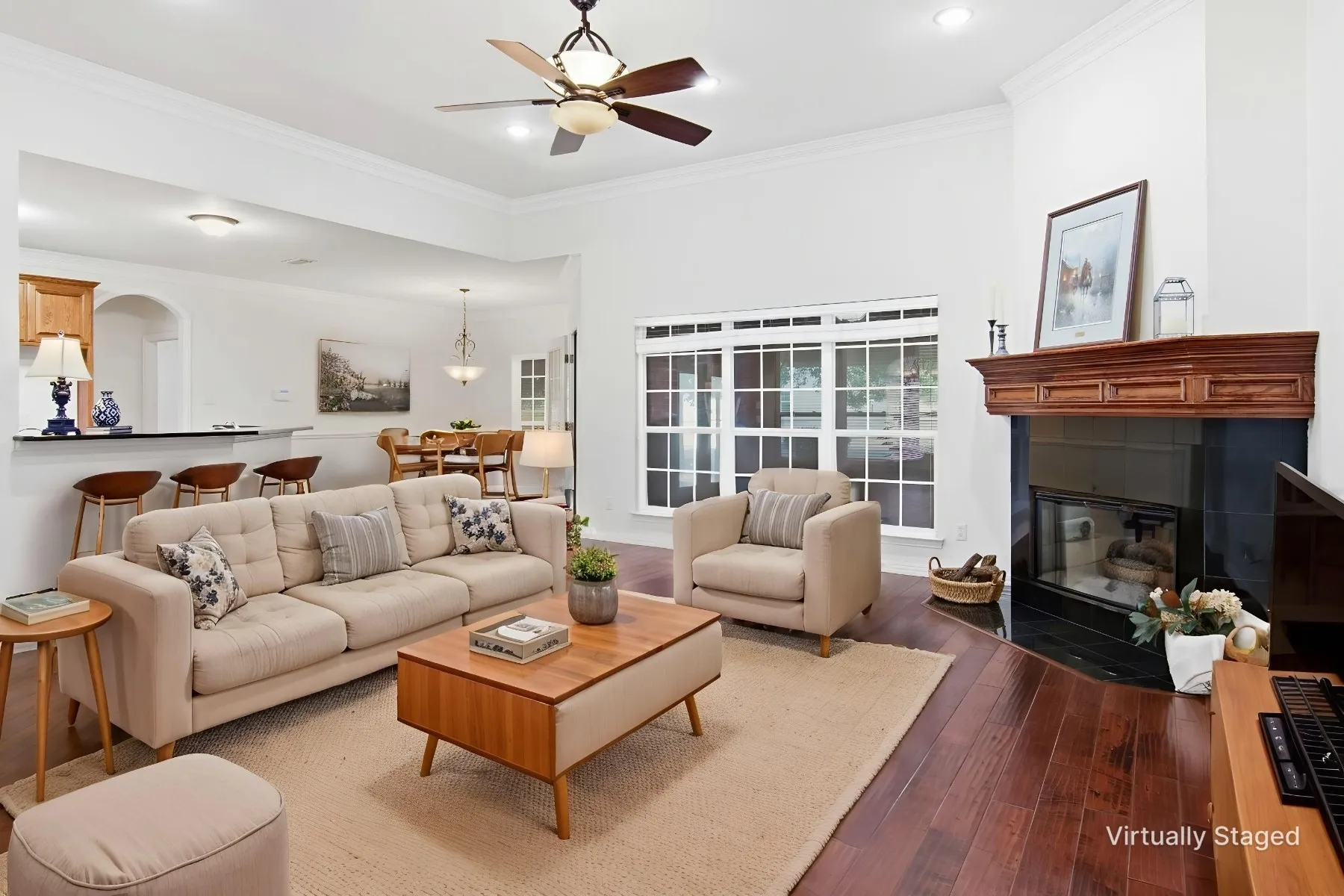 Staged family room, beautiful wood floors, wood burning fireplace, tall ceilings, crown moldings, wall of windows to enjoy the back yard views!