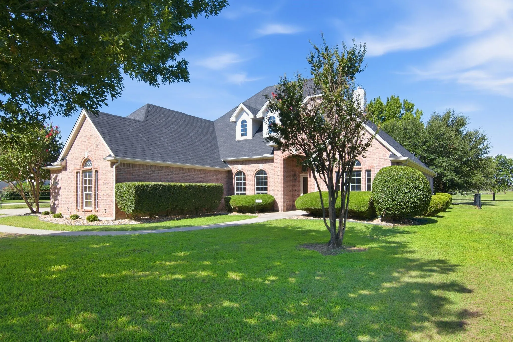 Gorgeous one story home, with lush landscaping and mature trees!