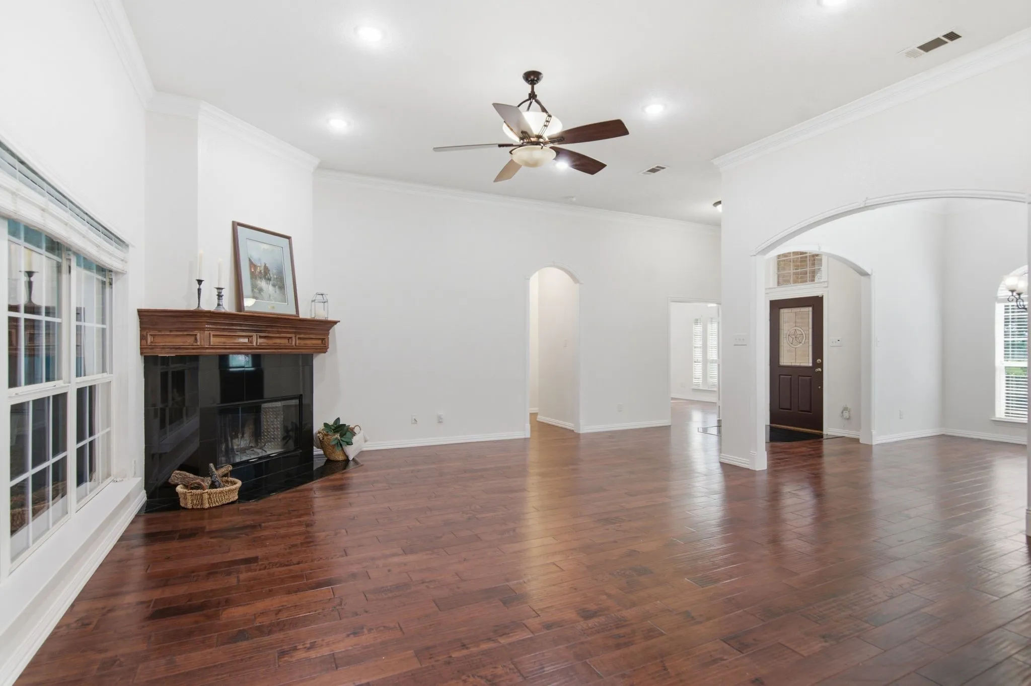 Living are, high ceilings, granite fireplace, arch openings, rich wood floors, open floor plan!