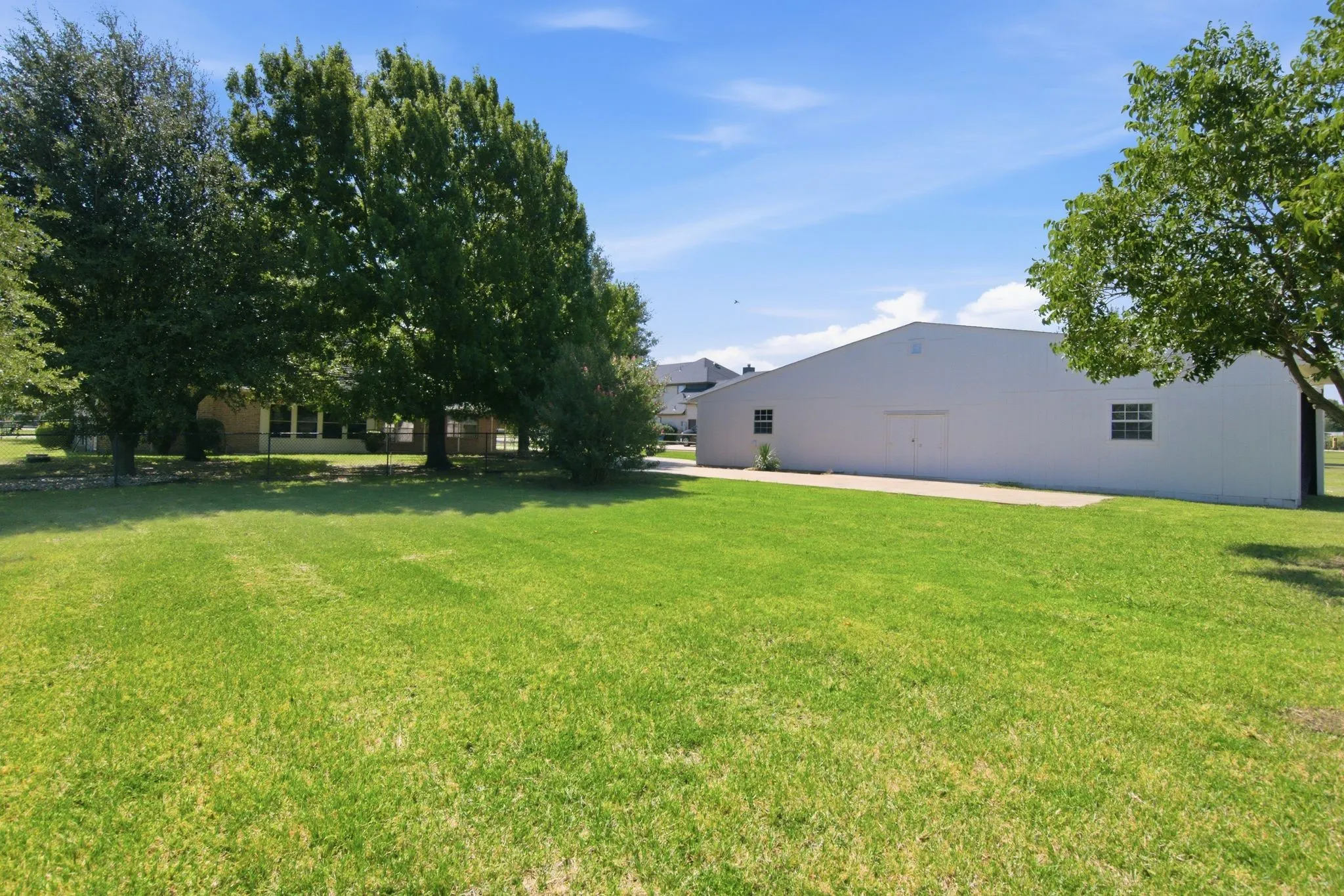 Backyard with mature trees, and workshop, garage & carport!